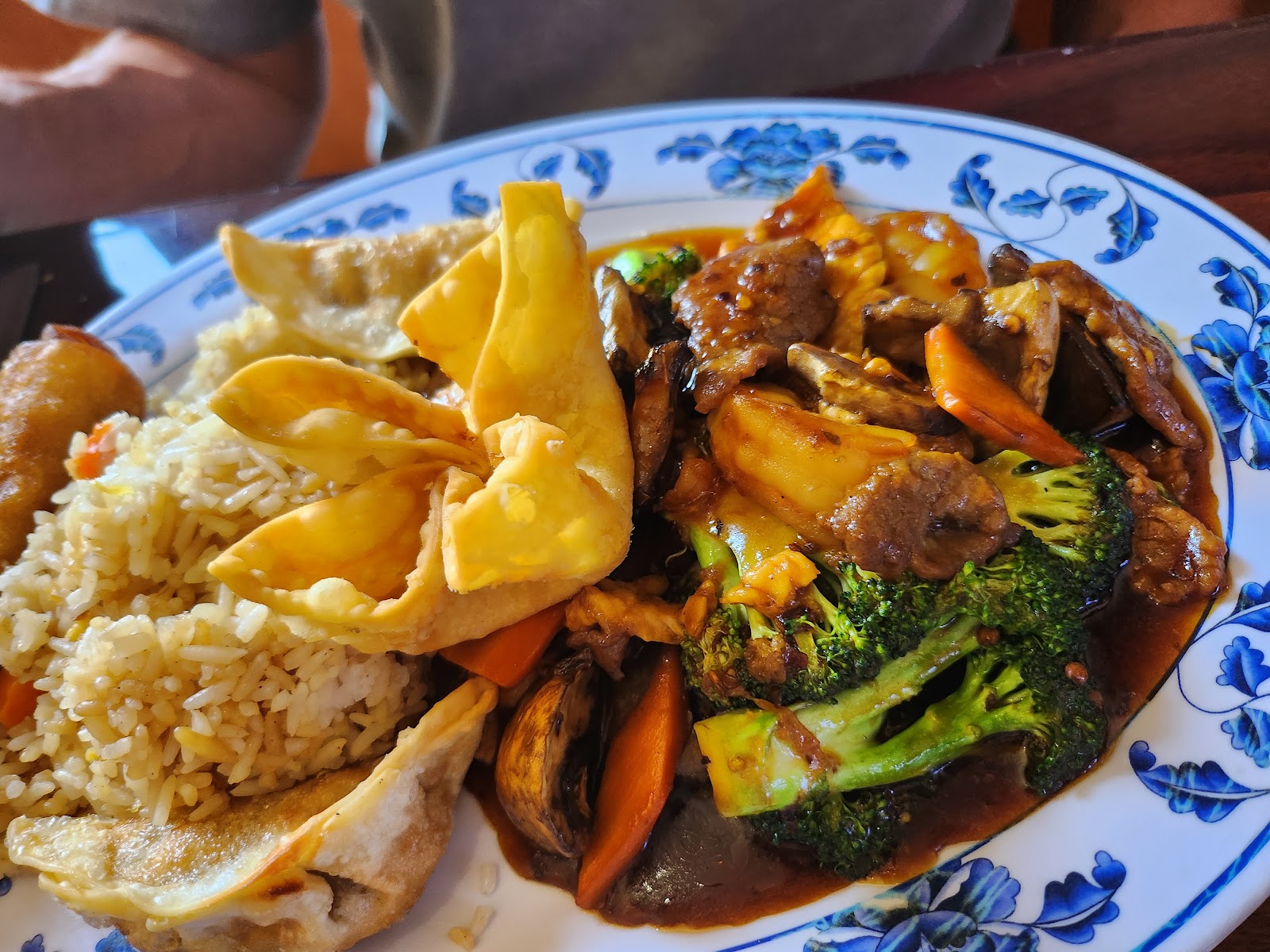 Beef and broccoli plate with wontons and fried rice